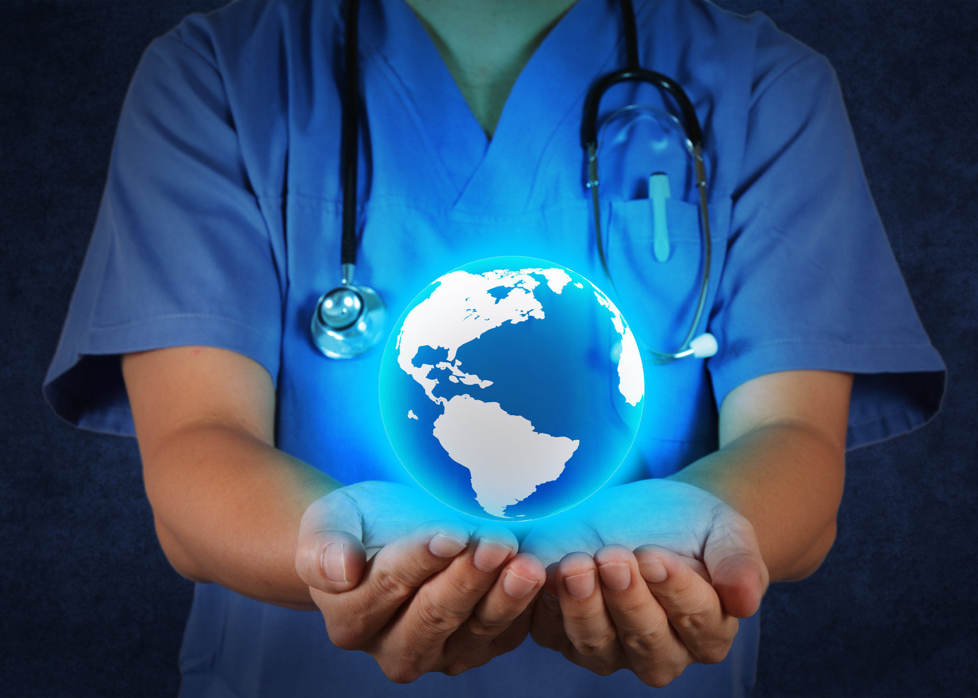 Medical Doctor holding a world globe in his hands as medical network concept