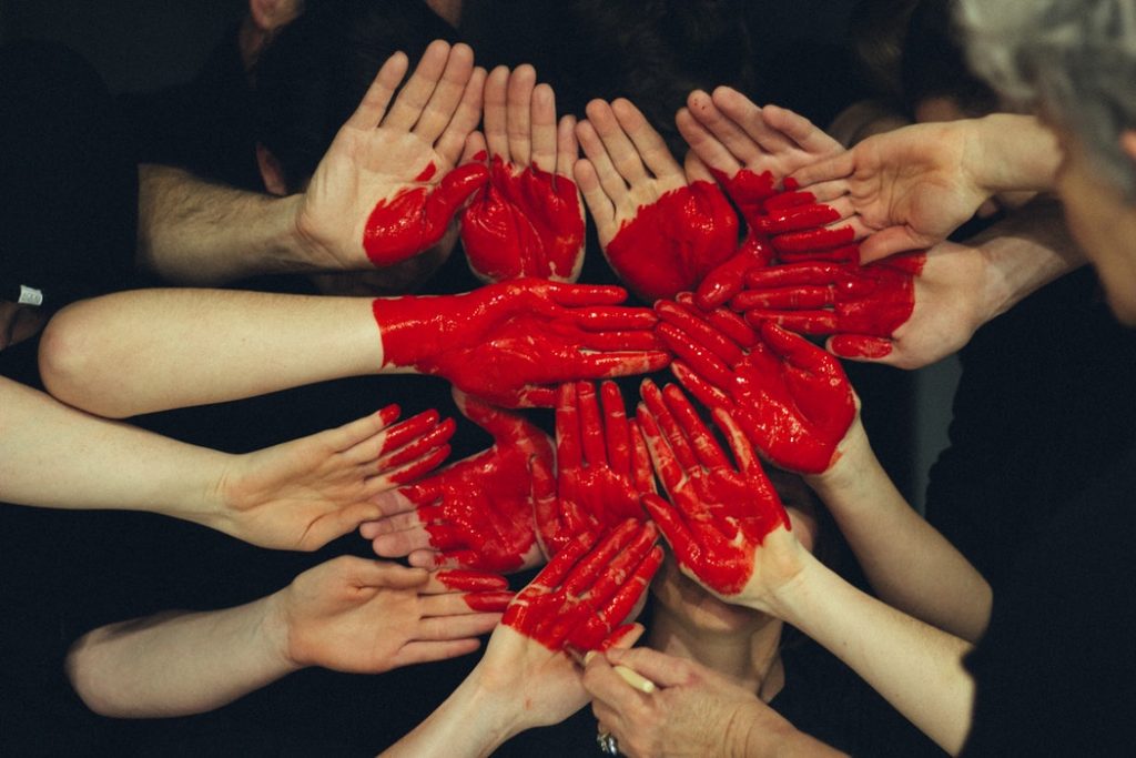 community hands painted with red