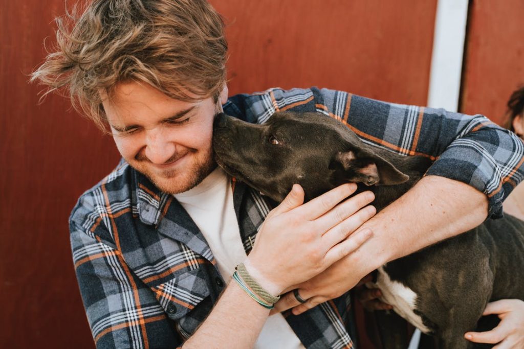 man happy hugging his dog