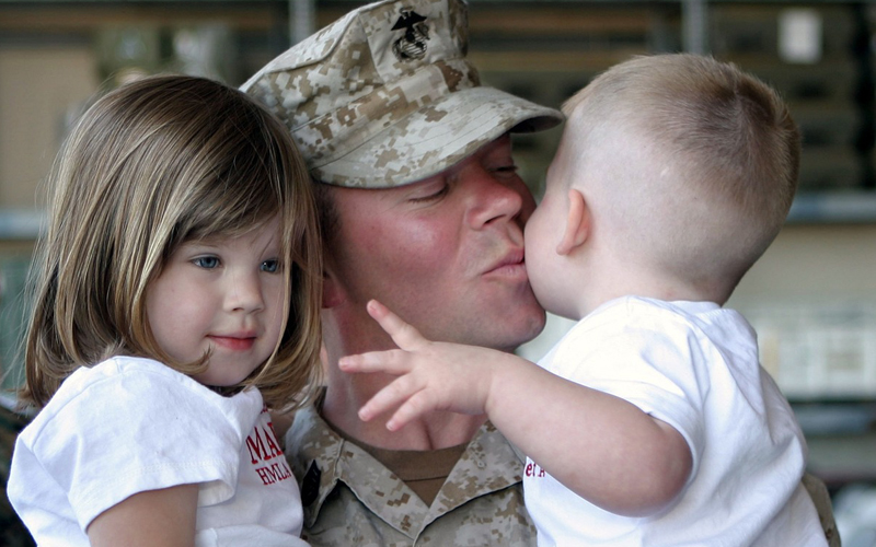 military kissing his son