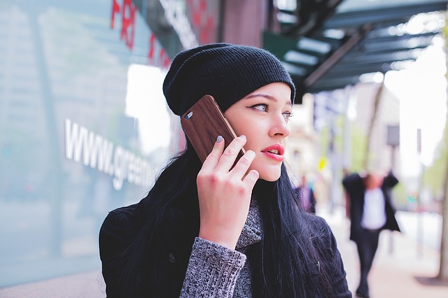 a woman talking to someone on her android phone