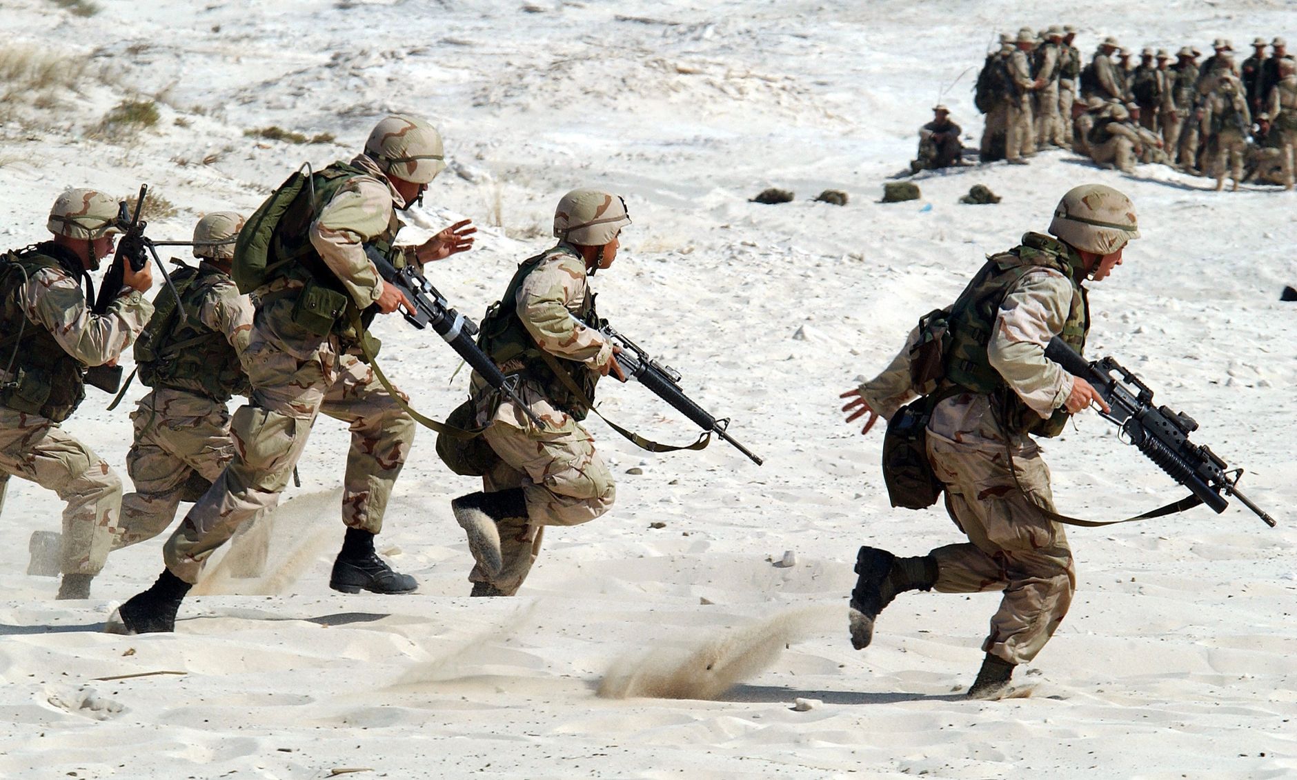 military men running in the snow