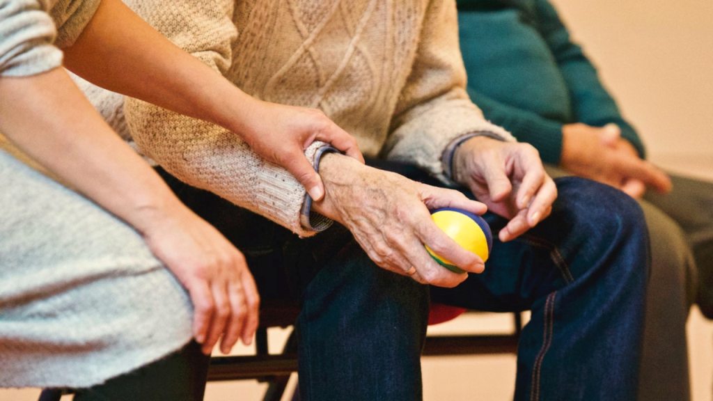 Elder holding stress ball in nursing home