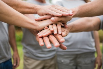 Happy volunteer family putting their hands together - feed my starving children