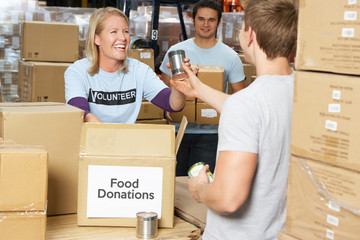 Volunteers Collecting Food Donations In Warehouse - feed my starving children