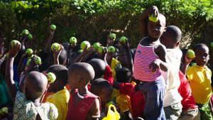 feed the children - children holding green apples